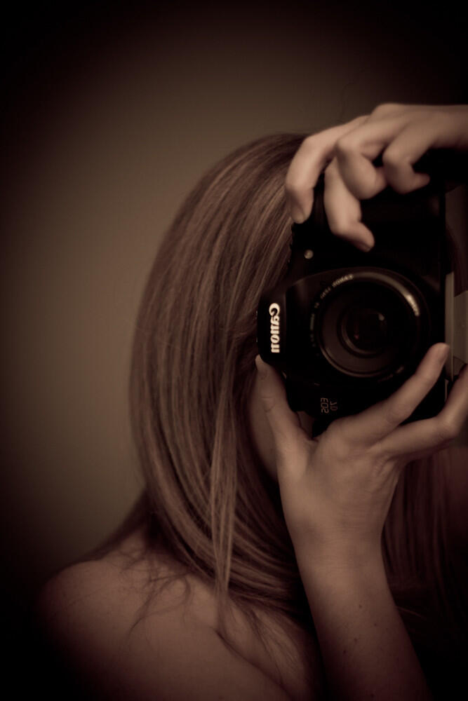 Self portrait with camera in hands
